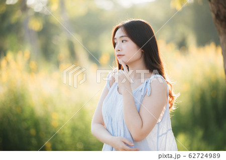 Portrait of Young Asian woman girl smile in flower garden 62724989