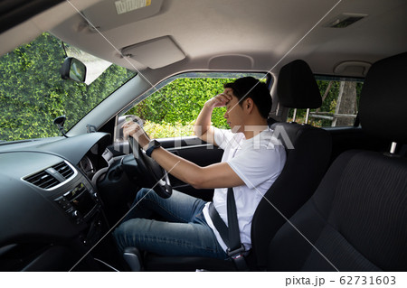 Tired young man sleep in car, Hard work causes Tired young man sleep in car, Hard work causes 62731603