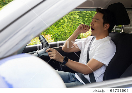 Tired young man sleep in car, Hard work causes 62731605