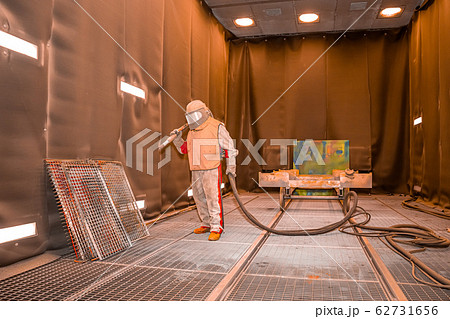 the worker processes the sandblast in the chamber the worker processes the sandblast in the chamber 62731656