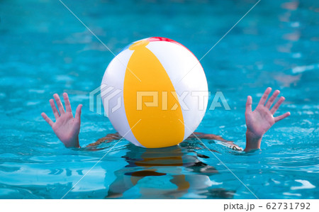 Teenager with a ball on his head in the pool Teenager with a ball on his head in the pool 62731792