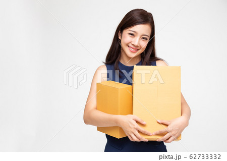 Happy Asian woman holding package parcel box, 62733332