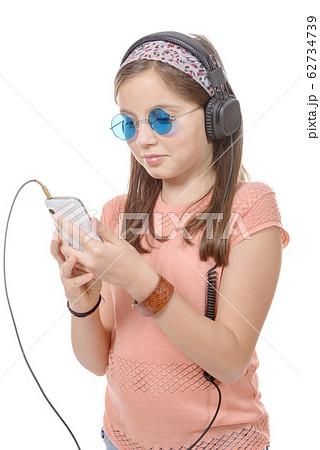 preteen girl listening to music with his 62734739
