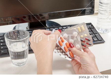 Pills with a computer, work pressure concept. 62734740
