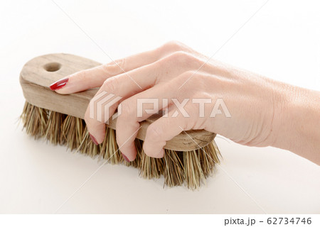 close up of woman hand using cleaning brush close up of woman hand using cleaning brush 62734746
