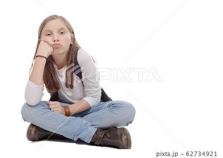 pretty little girl sitting cross-legged. Isolated 62734921