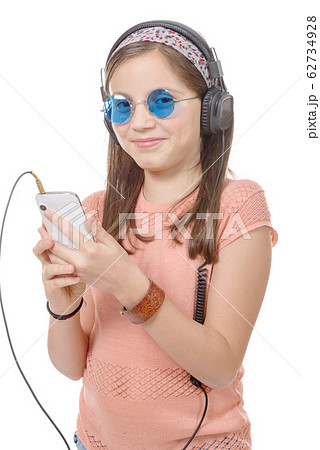 preteen girl listening to music with his 62734928