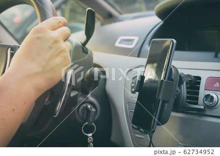 Smartphone charging in a car. 62734952