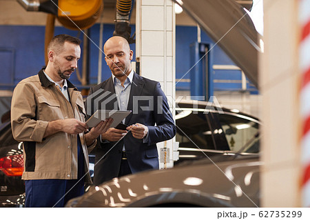 Businessman Checking in Car for Inspection Businessman Checking in Car for Inspection 62735299