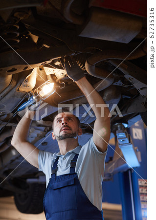 Car Mechanic Working in Shop Car Mechanic Working in Shop 62735316