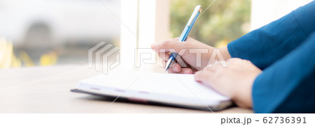 Closeup hand woman writer thinking idea and writing on notebook or diary with happy 62736391