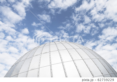 Shiny metallic observatory dome under cloudy sky 62739229