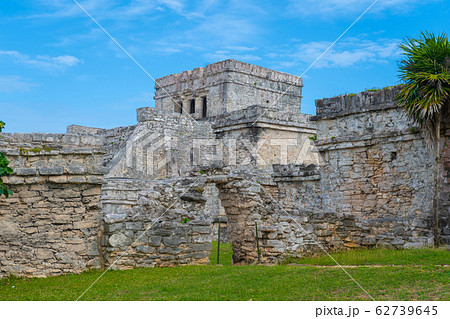 Ruins of ancient Tulum. Architecture of ancient maya. View with temple and other old buildings, houses. Blue sky and lush greenery of nature. travel photo. Wallpaper or background. Yucatan. 62739645