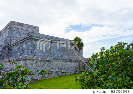 Ruins of ancient Tulum. Architecture of ancient maya. View with temple and other old buildings, houses. Blue sky and lush greenery of nature. travel photo. Wallpaper or background. Yucatan.  62739648