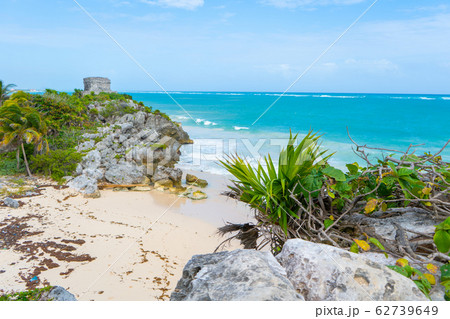 Ruins of ancient Tulum. Architecture of ancient maya. View with sea. Blue sky and lush greenery of nature. travel photo. Wallpaper or background. Yucatan. 62739649