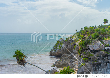 Caribbean coast near Tulum. Turquoise sea and blue sky. Nature with rocks and plants. Travel photo, background. Yucatan. Quintana roo. 62739658