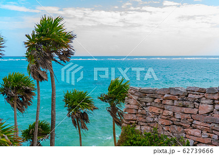 Ruins of ancient Tulum. Architecture of ancient maya. View with sea. Blue sky and lush greenery of nature. travel photo. Wallpaper or background. Yucatan. 62739666
