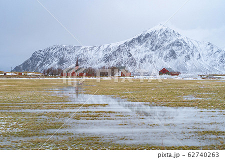 A church building and tomb grave with grass in 62740263