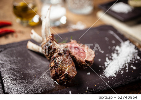 Grilled lamb chops served with a branch of rosemary 62740864