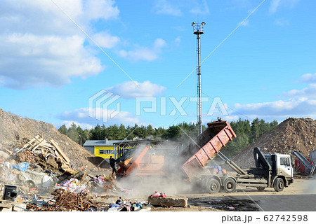 Garbage truck unloads construction waste from container at the landfill 62742598