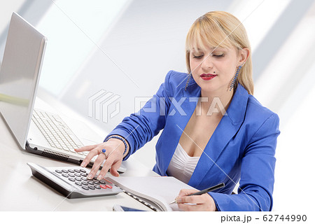 attractive blonde secretary sitting at her desk 62744990