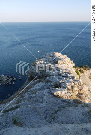 a steep grass-covered slope on the background of a a steep grass-covered slope on the background of a 62745399
