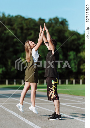 Girl with boyfriend clap their hands on the 62745509
