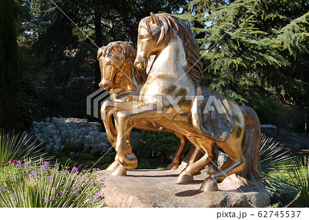 A monument with two golden horses shines from the A monument with two golden horses shines from the 62745537