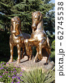 A monument to the sun shining in the sun with two 62745538