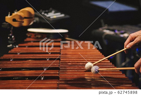 A man playing a marimba on a concert stage A man playing a marimba on a concert stage 62745898