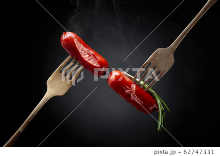 Grilled sausages with rosemary on a forks. Grilled sausages with rosemary on a forks. 62747331