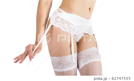 Close-up of female body in stockings and support belt isolated on white Close-up of female body in stockings and support belt isolated on white 62747555