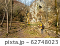 Female hiker arrives and admires a waterfall with a beautiful puddle of water 62748023