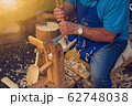 Craftsman carpenter builds wooden tools. 62748038