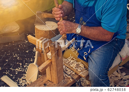 Craftsman carpenter builds wooden tools. Craftsman carpenter builds wooden tools. 62748038