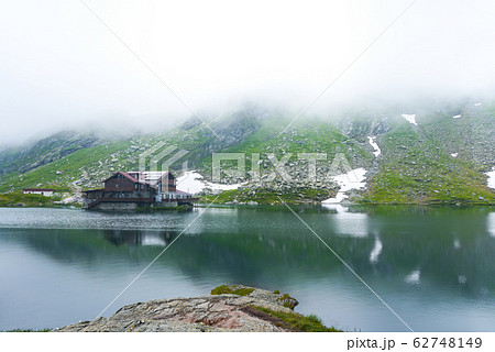 Majestic hose in fog, lake in mountains of Balea Majestic hose in fog, lake in mountains of Balea 62748149