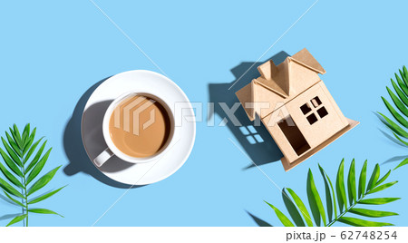 Cardboard house with a cup of coffee 62748254