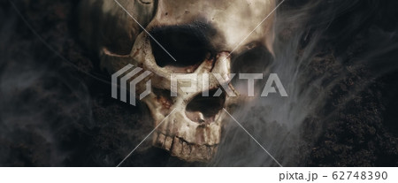 Skull of a dead man in on the ground 62748390