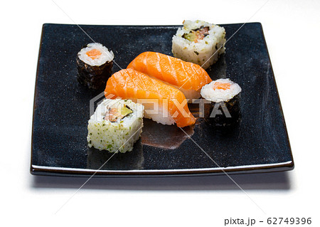 Black plate with sushi, maki and american rolls 62749396