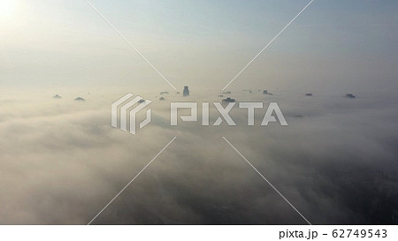 Aerial view of the city in the fog. Skyscrapers above the fog 62749543