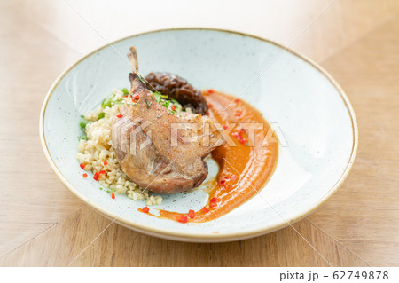 Plate Duck leg su-vide, with bulgur and onion marmalade. Barbecue restaurant menu, a series of photos of different meats Plate Duck leg su-vide, with bulgur and onion marmalade. Barbecue restaurant menu, a series of photos of different meats 62749878