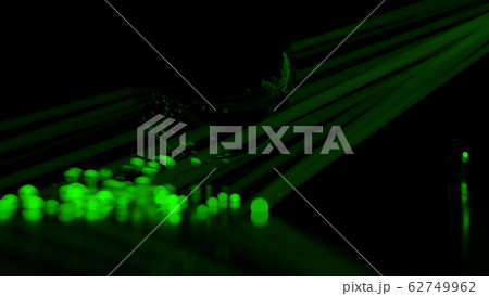 Abstract stream of spherical particles reflected from a large black circular sphere. Paricles are glowing green and have different brightness. 3d illustration with copyspace 62749962
