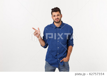Close up portrait of disappointed stressed bearded young man in shirt over white background. 62757354
