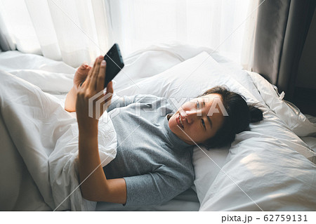 woman lying with smartphone woman lying with smartphone 62759131