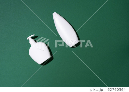 Shampoo and soap bottles on green background. Top view. Flat lay. Copy space. 62760564