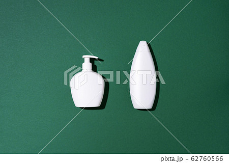 Shampoo and soap bottles on green background. Top view. Flat lay. Copy space. 62760566