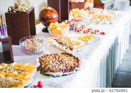 Delicious sweets on wedding candy buffet with desserts, cupcakes 62760861