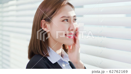 Woman use oil blotting paper 62762169