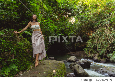 Happy woman by wild river stock photo 62762919