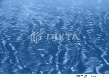 Close up abstract water texture. Swimming pool water in monochrome color background. Trendy blue and calm color. Copy space, top view. Close up abstract water texture. Swimming pool water in monochrome color background. Trendy blue and calm color. Copy space, top view. 62762950